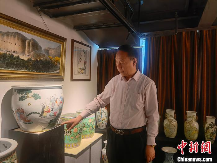 劉世杰向記者介紹自己收藏的文物?！「呖档?攝